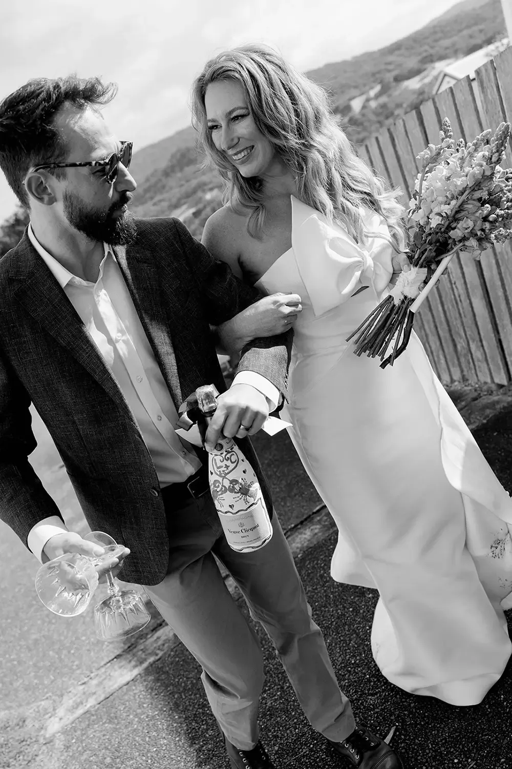Bride with natural bridal makeup laughing candidly with her groom